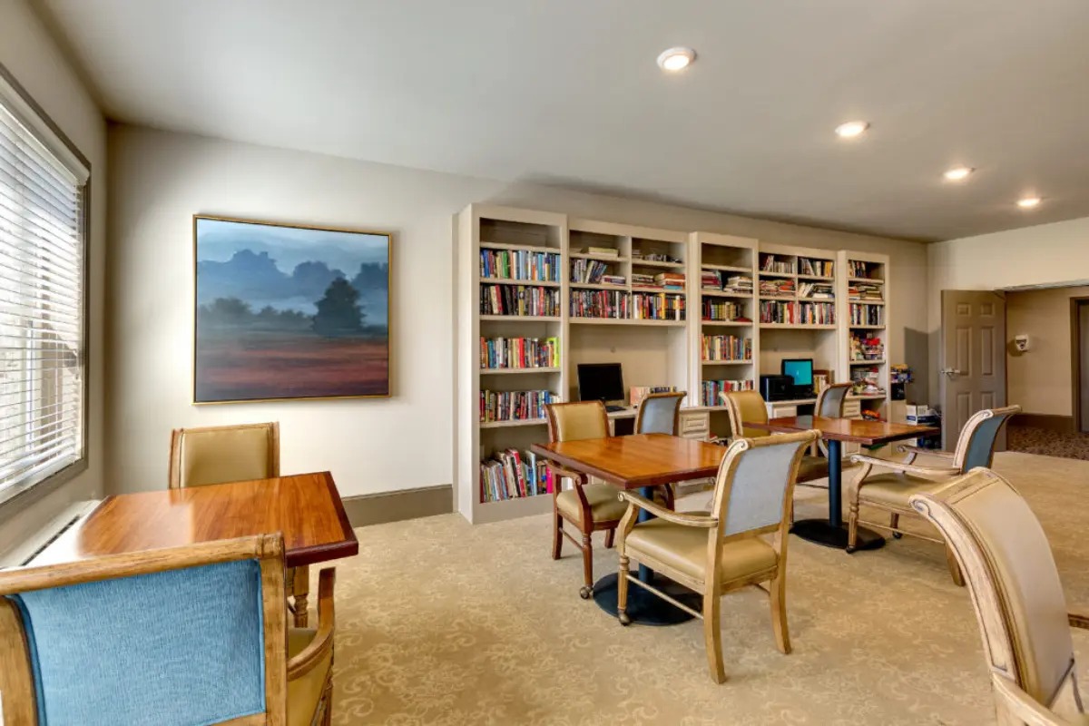 Cozy reading room with bookshelves and tables.